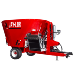Red Jay-Lor feed mixer wagon with wheels and hitch, used to blend animal feed on a farm?