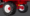 Close-up of red agricultural vehicle wheels with large knobby tires, white rims, and red hubs on a gray background.