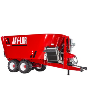 6850HD Red Jay-Lor 6850HD feed mixer wagon with dual rear wheels and hitch, used for bulk livestock feed.