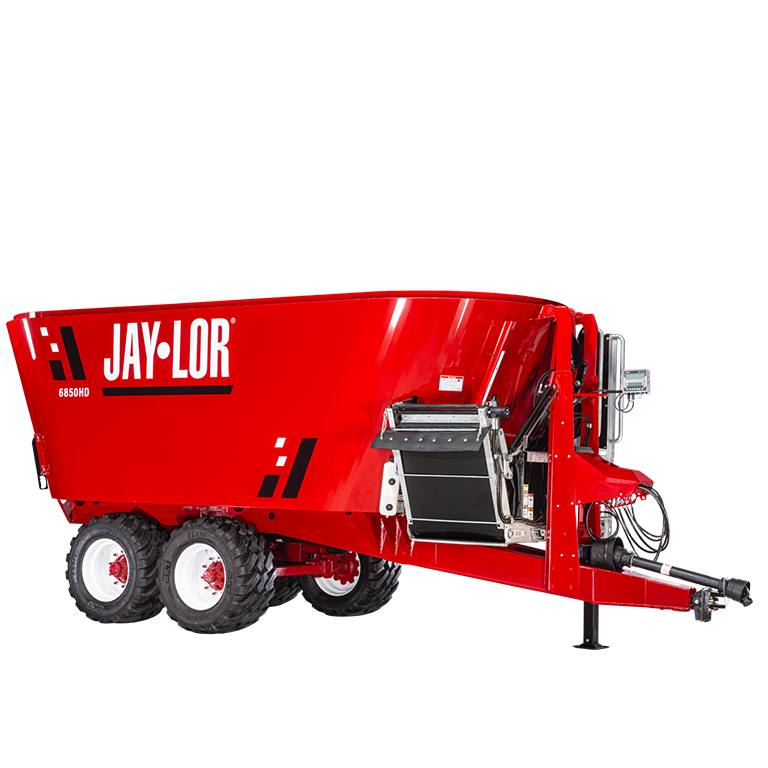 Red Jay-Lor 6850HD feed mixer wagon with dual rear wheels and hitch, used for bulk livestock feed.
